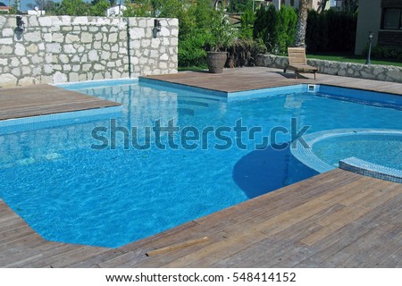 Residential inground swimming pool Royalty-Free Stock Photo #548414152
