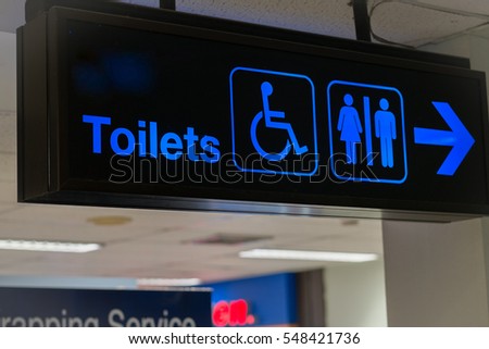Airport toilet signs, blue on black