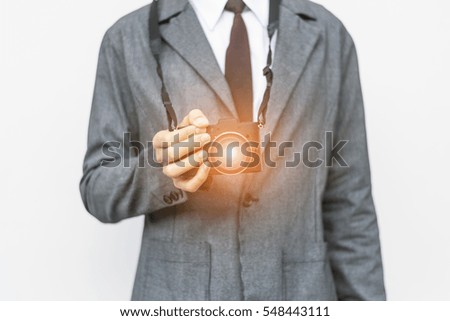 Business man holding black digital camera