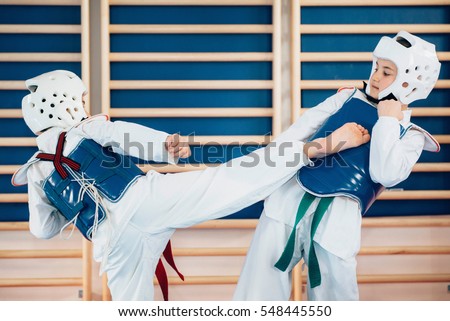 Two kids sparing on tae kwon do Royalty-Free Stock Photo #548445550