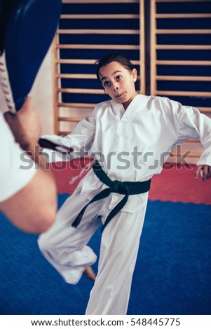 Girl on Tae kwon do training with trainer