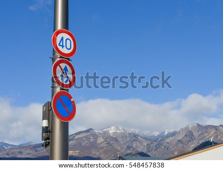Traffic Signs for Speed limits, prohibiting overtaking and No parking with mountain and blue sky background