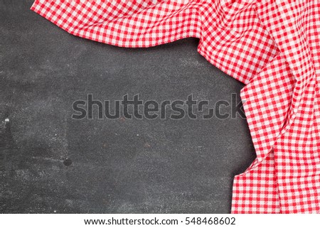 Red picnic cloth on wooden background.Napkin tablecloth on old wood with empty space for text.