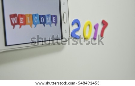 Welcome from screen phone for new year 2017  isolated on white background