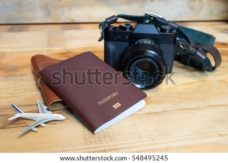 Travel item photo camera, Passports,  on a wooden floor.