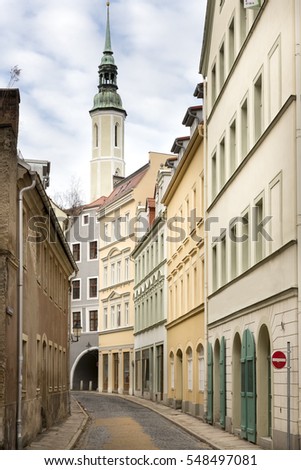 Picturesque alley in the town of Goerlitz, Germany, with the trinity church in the background