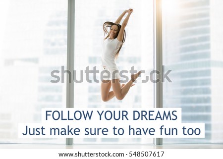 Young smiling woman in a modern room jumping high for joy. Photo with motivational text "Follow your dreams. Just make sure to have fun too"