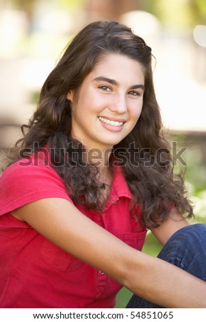 Portrait Of  Teenage Girl Sitting In Park