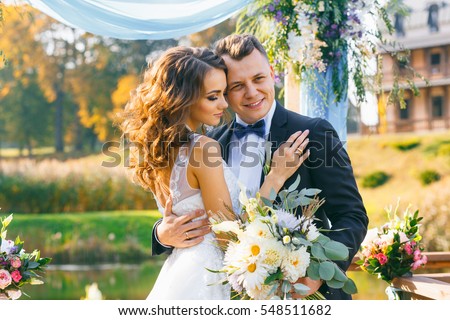 creative stylish wedding ceremony elegant curly bride and groom outdoors on the background the lake