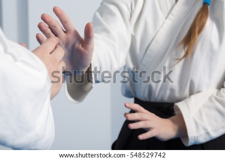 Hands of two girls practice Aikido on martial arts training Royalty-Free Stock Photo #548529742