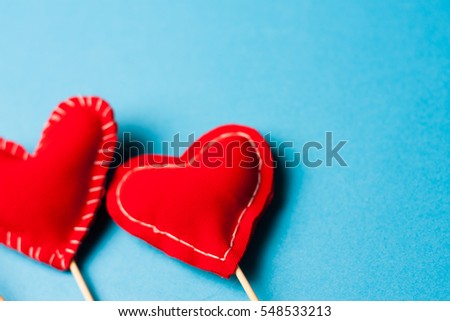Rag hearts in a row on a bright blue background