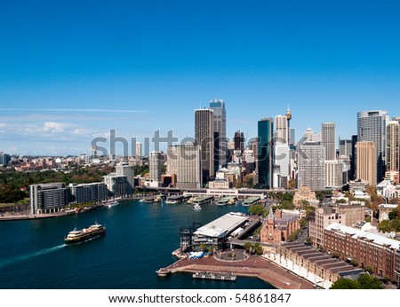 Circular Quay business district in Sydney Australia with a ferry entering the harbor