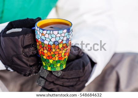 Young man pours and drinks tea from a thermos. people and healthy lifestyle concept