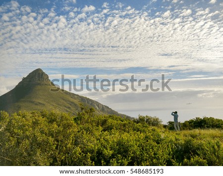 Male person taking a picture of african landscape, Africa