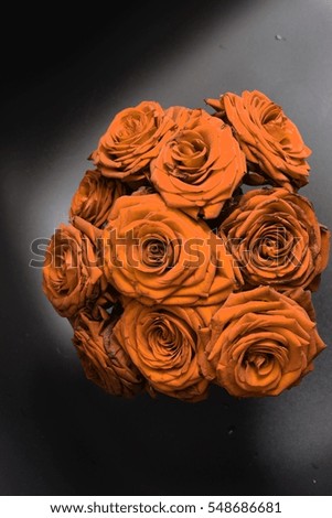Arrangement of orange blooming roses. Romantic bouquet with withering flowers for birthday gift, mothers day, valentines love present, wedding and bridal decoration. Image with vintage filter effect.