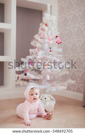 Beautiful little baby celebrates Christmas. New Year's holidays.