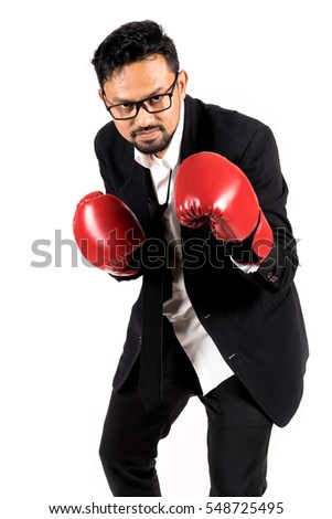 Businessman with boxing gloves ready to fight