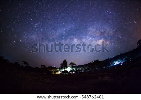 Milky way and silhouette of tree at Phu Hin Rong Kla National Park,Phitsanulok Thailand, Long exposure photograph.with grain