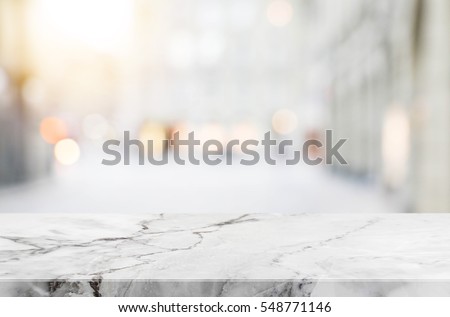 Stone table top and blurred shopping plaza background - can used for display or montage your products.