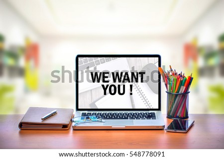 Open laptop with isolated white screen on old wooden desk with text WE WANT YOU