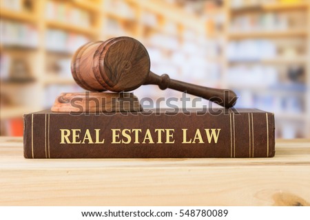 real estate law books and a gavel on desk in the library. concept of legal education.