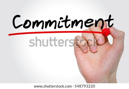 Hand writing inscription "Commitment" with marker, concept