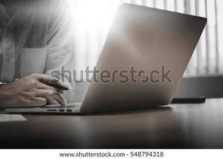 Close up of businessman working in his office with smart phone,document and laptop in business concept