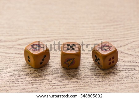 Brown dices on wooden background. Concept of luck, chance and leisure fun./ Sensitive Focus / this dice by handmade