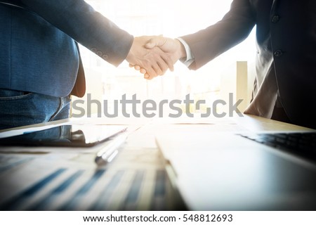 Two confident business man shaking hands during a meeting in the office, success, dealing, greeting and partner concept. Royalty-Free Stock Photo #548812693