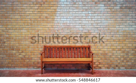 Wood bench and brick wall background