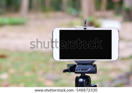 Mobile phone camera on a tripod .
