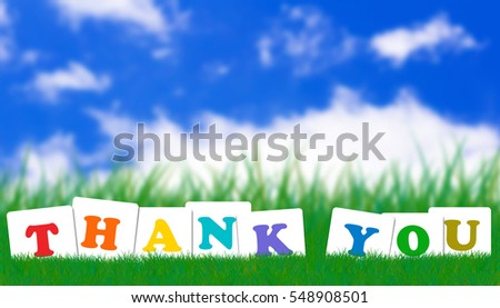 Word thank you concept on green grass and blue sky