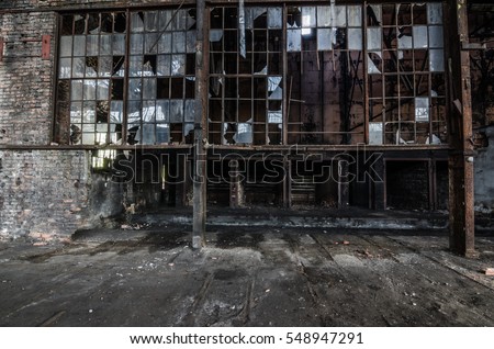 abandoned old factory with broken windows Royalty-Free Stock Photo #548947291