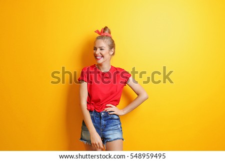 Young cool woman on yellow background