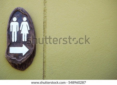 Restroom sign with light Green cement wall background
