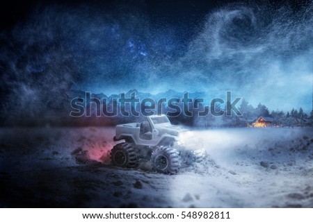 Toy Car in winter forest, night driving in winter - warning sign night driving in winter - warning sign: risk of snow and ice. Concept. 