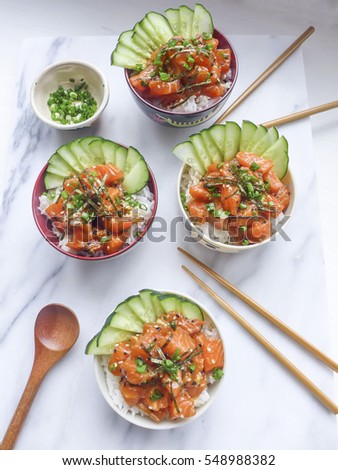 Delicious homemade Hawaiian  poke bowl rice with raw salmon fish and dressing toppings / Poke bowl / Easy and fun, healthy and light meal for weight-watcher
