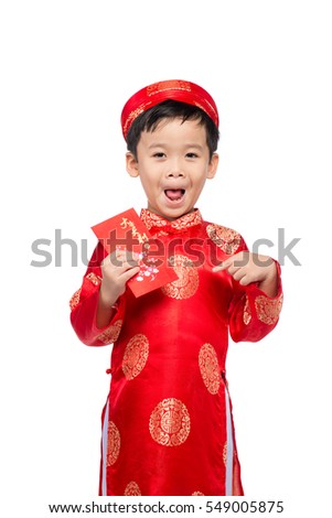 Little Vietnamese boy holding red envelops for Tet. The word mean double happiness. It is the gift in lunar new year or Tet Holiday on red isolate background.