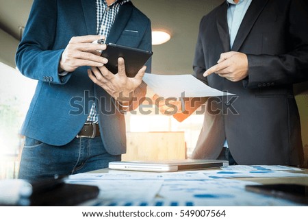 Businessmen hands pointing at document in touch-pad during explanation of new plan project data at meeting. Royalty-Free Stock Photo #549007564