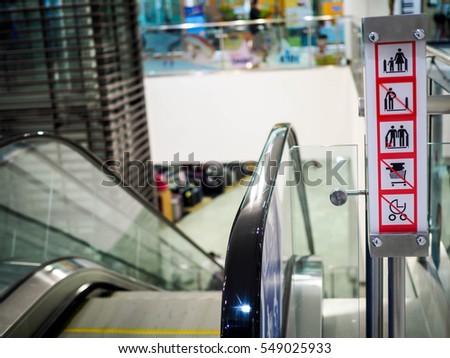 Do not use escalator, moving staircase with unattended child. Prohibition sign and moving staircase with pushchair. Prohibition sign and moving staircase when it is moving reverse direction, 