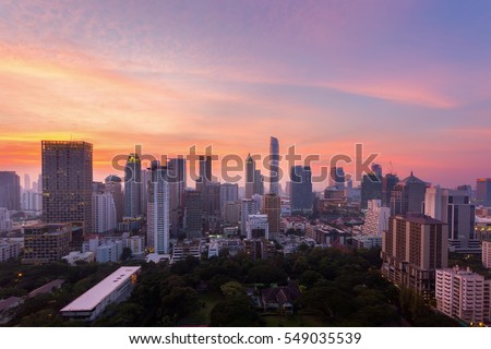 Aerial view of Bangkok modern office buildings, condominium in Bangkok city downtown with sunset sky ,Bangkok is the most populated city in Southeast Asia , Thailand.