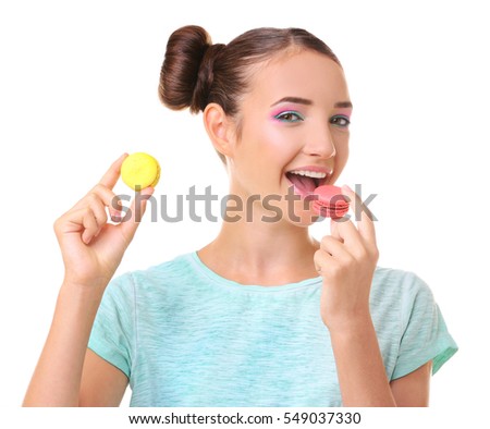 Cute girl with macaroons on white background