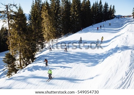 Snowboarder skating in the mountains with deep blue sky
