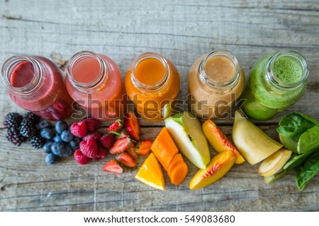 Selection of colorful smoothies on rustic wood background, copy space Royalty-Free Stock Photo #549083680