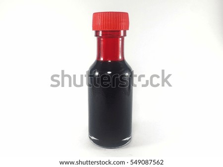 Liquid red food color additive over white background