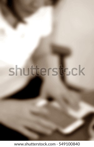 Blurred  background abstract and can be illustration to article of businesswoman use mobile phone