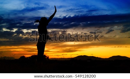 Let success together, silhouette of woman and beautiful twilight with sunset