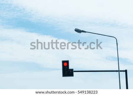 Red traffic lights with blue sky.