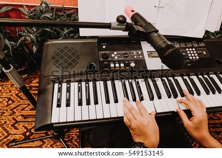 selective focus and closeup view of music instrument, man hand play electronic keyboard 