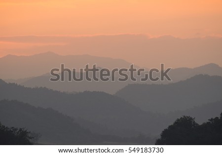 Sunset sky with layer of mountain, countryside